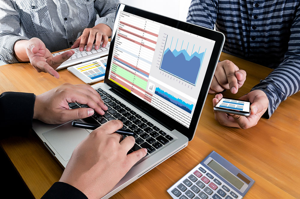 People Looking At Analytics On Devices